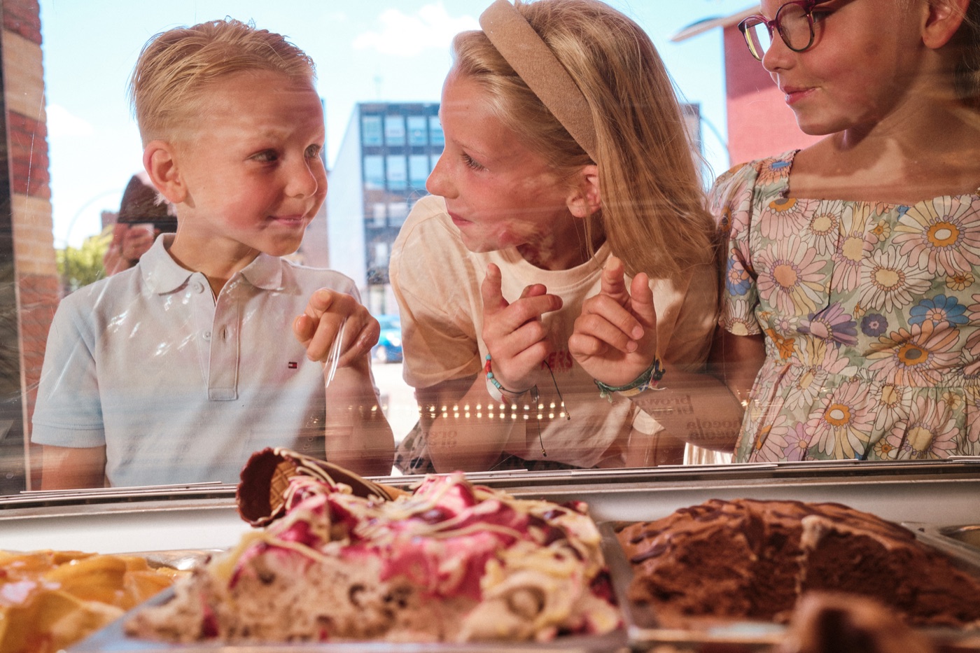 Kinderen kiezen ijs bij de vitrine